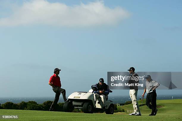 Mathew Goggin, Geoff Ogilvy and Peter O'Malley speak to tournament director Andrew Langford-Jones before play was suspended due to prevailing winds...