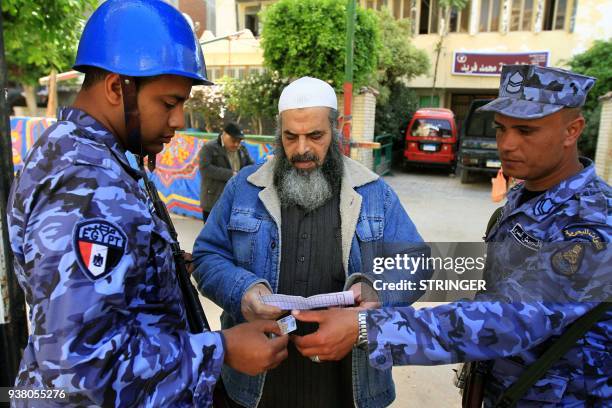 Egyptian naval conscripts check the ID of a conservative Salafi voter outside a polling station in al-Montazah district of Egypt's second city of...