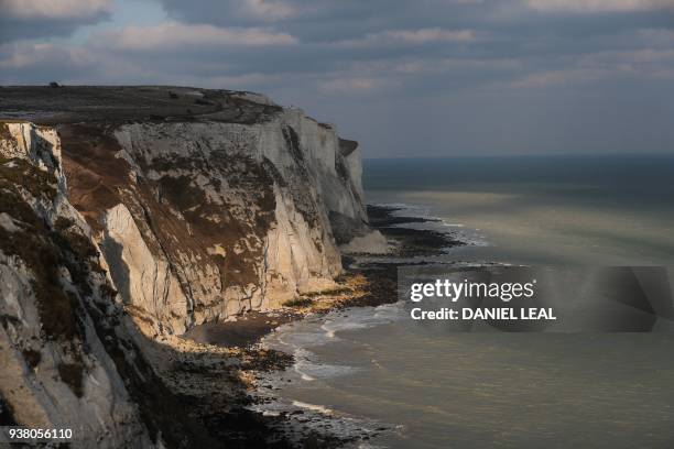 The White Cliffs of Dover are seen on the south coast of England on March 19, 2018. - Despite being the UK's gateway to Europe, locals in Dover on...