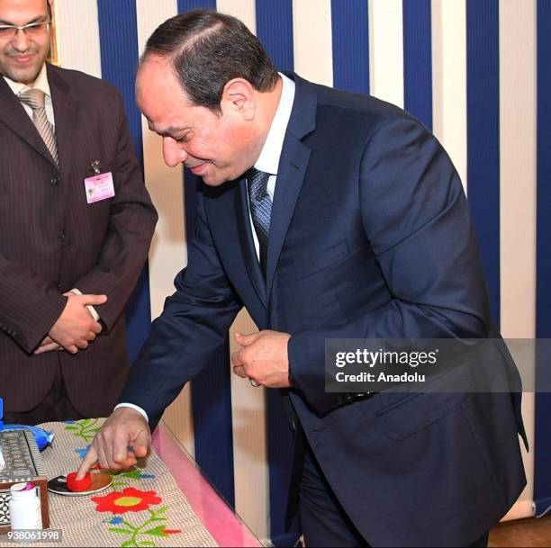 Egyptian President Abdel Fattah al-Sisi casts his ballot during the Egypts presidential election at the Mustafa Yousry Amira secondary school in...