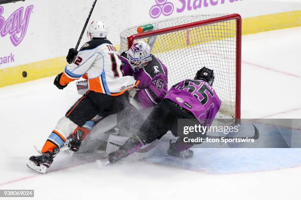 San Diego Gulls right wing Corey Tropp and Cleveland Monsters defenceman Garret Cockerill collide with Cleveland Monsters goalie Matiss Kivlenieks...
