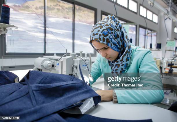 January 01: Production hall of the textile company Sartex. A seamstress at work on January 01, 2000 in KSAR HELLAL, TUNISIA.