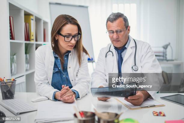 doctors working together - radiographer stock pictures, royalty-free photos & images