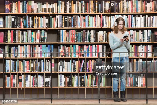 student with glasses and headphones, reading book - sweden school stock pictures, royalty-free photos & images