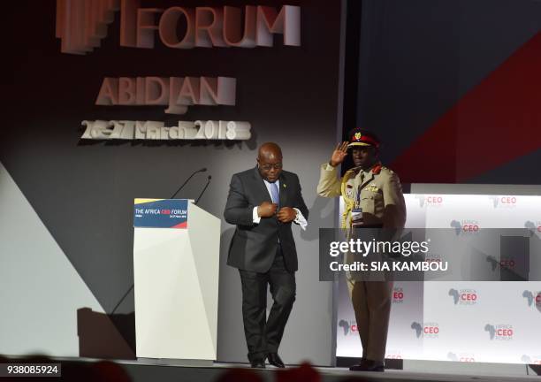 Ghanean president Nana Akufo-Addo leaves with his aide-de-camp after delivering a speech during the opening session of the AFRICA CEO FORUM in...