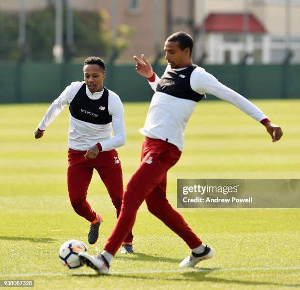 Joel Matip and Nathaniel Clyne of Liverpool during a training session at Melwood training ground on March 26, 2018 in Liverpool, England.