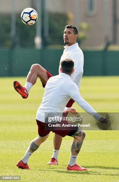 Dejan Lovren and Albero Moreno of Liverpool during a training session at Melwood training ground on March 26, 2018 in Liverpool, England.