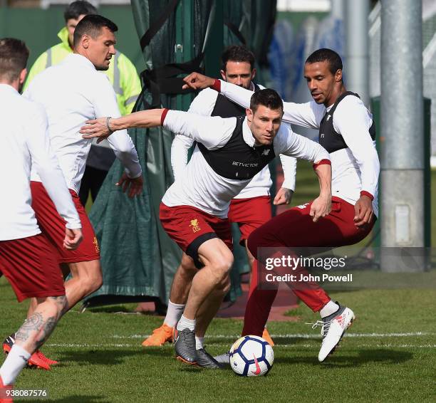James Milner and Joel Matip of Liverpool during a training session at Melwood training ground on March 26, 2018 in Liverpool, England.