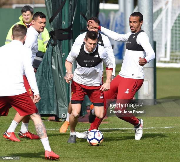 James Milner and Joel Matip of Liverpool during a training session at Melwood training ground on March 26, 2018 in Liverpool, England.