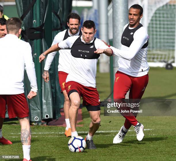 James Milner and Joel Matip of Liverpool during a training session at Melwood training ground on March 26, 2018 in Liverpool, England.