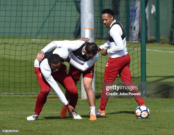 Joel Matip and James Milner of Liverpool during a training session at Melwood training ground on March 26, 2018 in Liverpool, England.