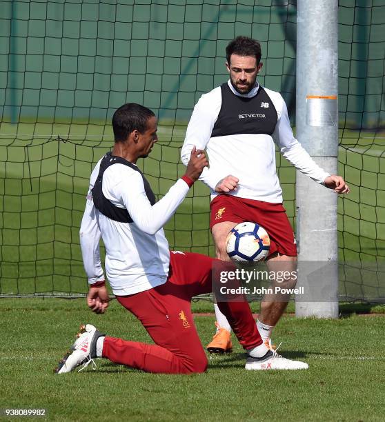 Joel Matip and Danny Ings of Liverpool during a training session at Melwood training ground on March 26, 2018 in Liverpool, England.