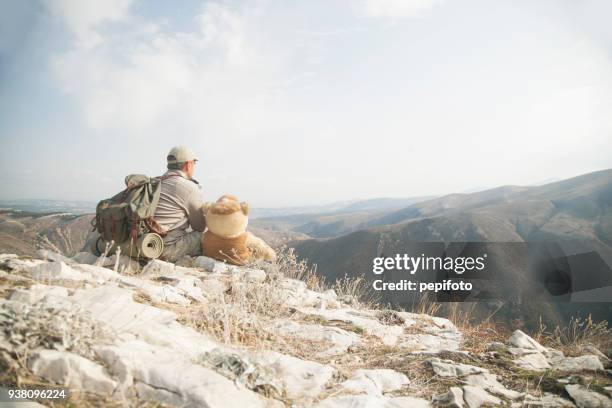 man sits with  bear toy - bear camping stock pictures, royalty-free photos & images