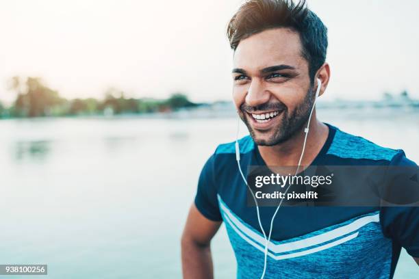middle-eastern ethnicity sportsman - mp3 player stock pictures, royalty-free photos & images