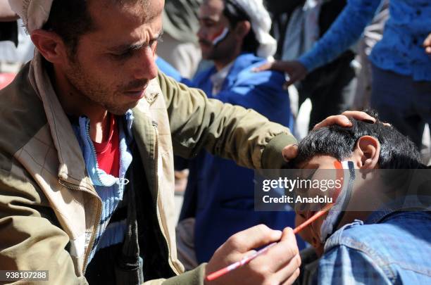 Houthis gather to protest the Saudi-led operations during a rally on the third anniversary of the Operation Decisive Storm at al-Sabin Square in...