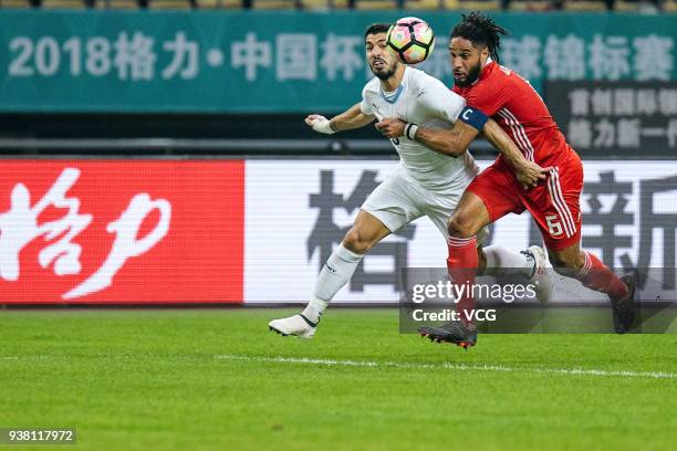 Ashley Williams of Wales and Luis Suarez of Uruguay compete for the ball during the 2018 China Cup International Football Championship match between...