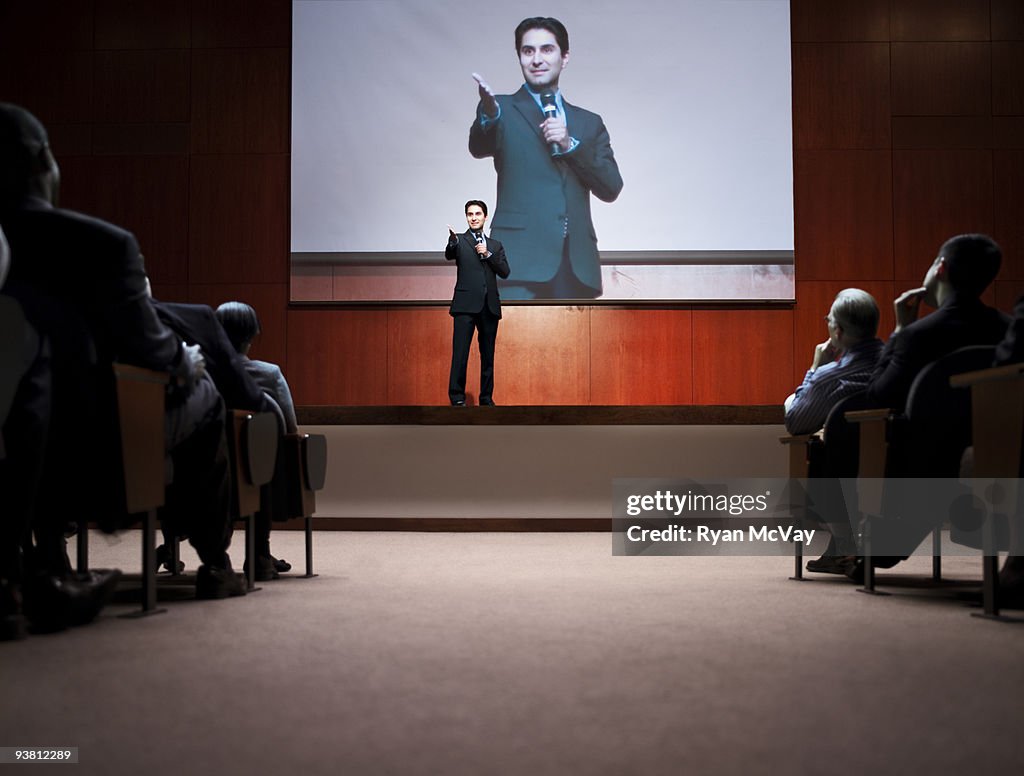 Business man making speech to crowd