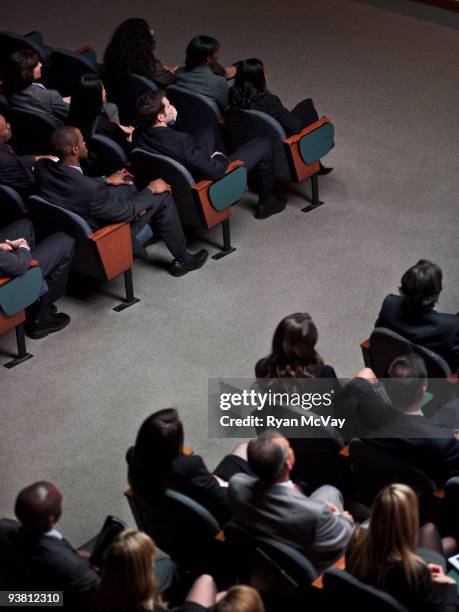 business crowd in auditorium - auditorium stock pictures, royalty-free photos & images