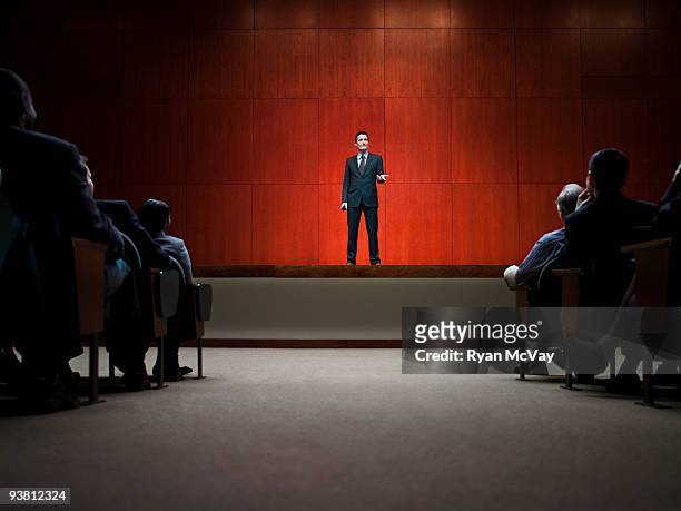 business man making speech in front of crowd - discorso foto e immagini stock