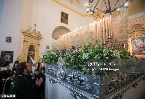 The brotherhood of the "Virgen de la Paz" could not leave to march due to the heavy rain at night. A man sings a "saeta" to the "Virgen de la Paz"...