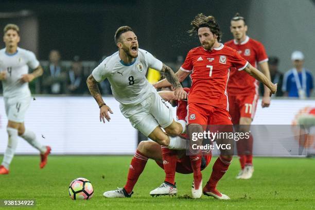 Joe Allen of Wales and Nahitan Nandez of Uruguay compete for the ball during the 2018 China Cup International Football Championship match between...