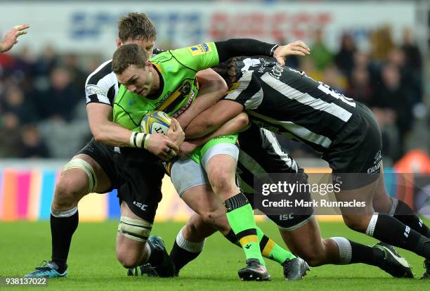 George North of Northampton Saints is tackled by Sam Lockwood and Calum Green of Newcastle Falcons during the Aviva Premiership match between...