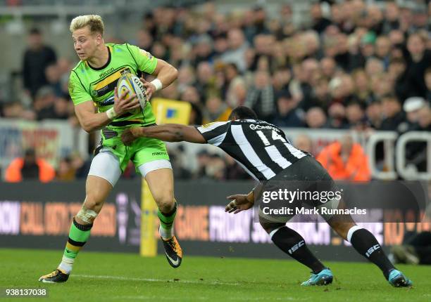 Harry Mallinder of Northampton Saints is tackled by Vereniki Goneva of Newcastle Falcons during the Aviva Premiership match between Newcastle Falcons...