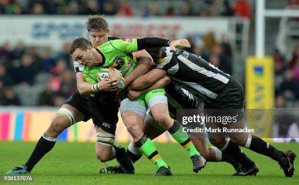 George North of Northampton Saints is tackled by Sam Lockwood and Calum Green of Newcastle Falcons during the Aviva Premiership match between...