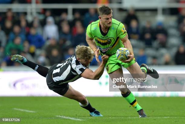 Rob Horne of Northampton Saints is tackled by Chris Harris of Newcastle Falcons during the Aviva Premiership match between Newcastle Falcons and...