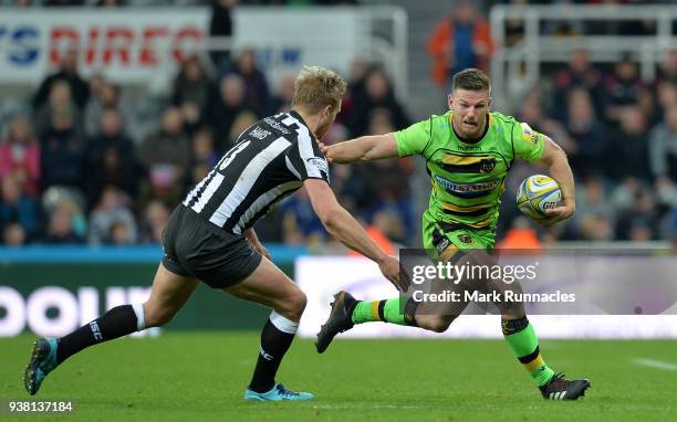 Rob Horne of Northampton Saints is tackled by Chris Harris of Newcastle Falcons during the Aviva Premiership match between Newcastle Falcons and...