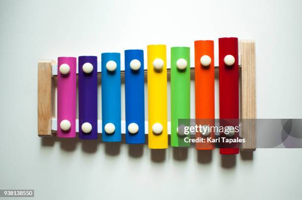 a multi colored xylophone - xylophone stock-fotos und bilder