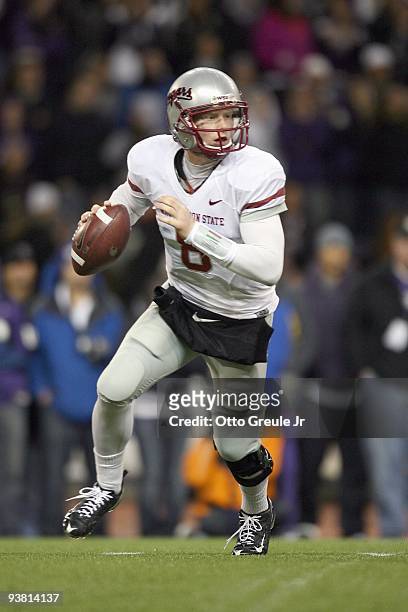 Quarterback Marshall Lobbestael of the Washington State Cougars runs to pass the ball during the game against the Washington Huskies on November 28,...