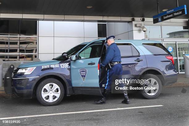 Massachusetts State Police trooper gets into a Troop F SUV in front of Terminal A at Logan Airport in Boston on March 23, 2018. Revelations about an...