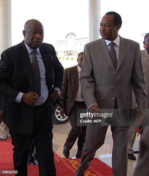 Ivorian President Laurent Gbagbo and President Blaise Compaore of Burkina Faso arrive for a meeting on December 3, 2009 in Ouagadougou as part of the...