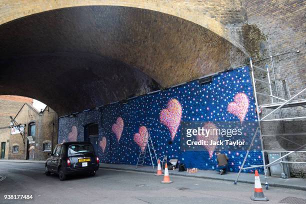 British-born Australian artist James Cochran, known as 'Jimmy C', puts the finishing touches to a mural to commemorate the victims of the London...