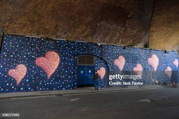 British-born Australian artist James Cochran, known as 'Jimmy C', puts the finishing touches to a mural to commemorate the victims of the London...