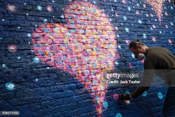 British-born Australian artist James Cochran, known as 'Jimmy C', puts the finishing touches to a mural to commemorate the victims of the London...