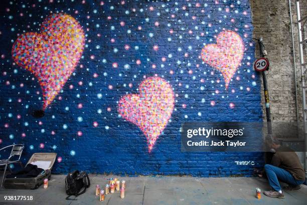 British-born Australian artist James Cochran, known as 'Jimmy C', puts the finishing touches to a mural to commemorate the victims of the London...