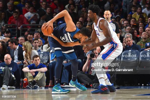 Joel Embiid of the Philadelphia 76ers guards Karl-Anthony Towns of the Minnesota Timberwolves on March 24, 2018 in Philadelphia, Pennsylvania at the...