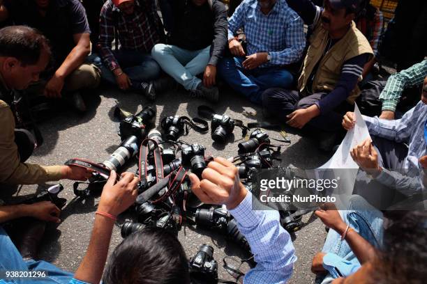 Photojournalists put down their cameras in protest against Delhi Police's recent assault on media in New Delhi on March 26, 2018. Members of the...