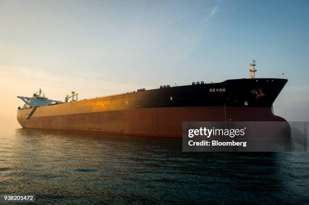 The oil tanker 'Devon' sails at sunset towards Kharq Island to transport crude oil to export markets in Bandar Abbas, Iran, on Friday, March 23,...