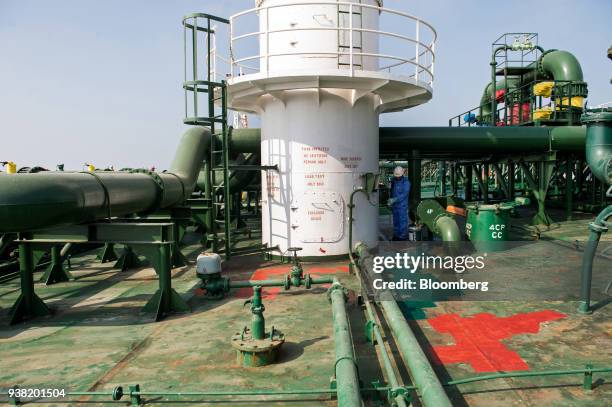 Crew member works on the deck of oil tanker 'Devon' as it prepares to ship crude oil from Kharq Island oil terminal to India in the Persian Gulf,...