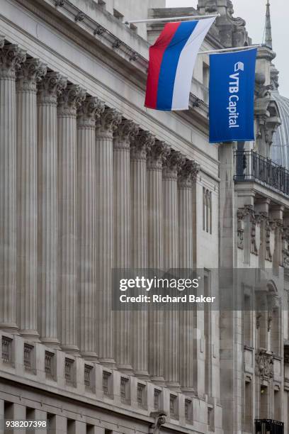 The flags of the Russian Federation and Russian investment Bank VTB Capital hang over banks and other financial institutions in the City of London,...