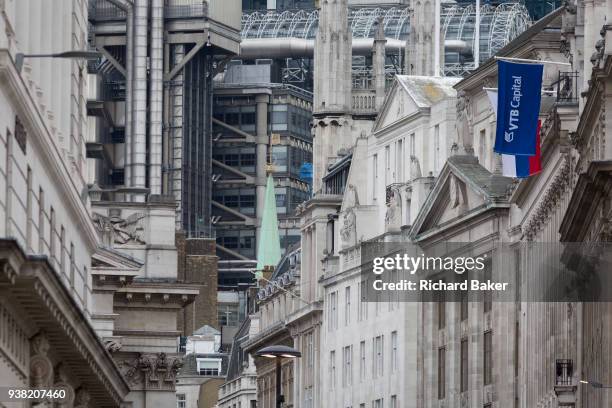 The flags of the Russian Federation and Russian investment Bank VTB Capital hang over banks and other financial institutions in the City of London,...