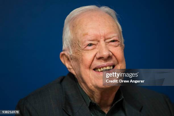 Former U.S. President Jimmy Carter smiles during a book signing event for his new book 'Faith: A Journey For All' at Barnes & Noble bookstore in...