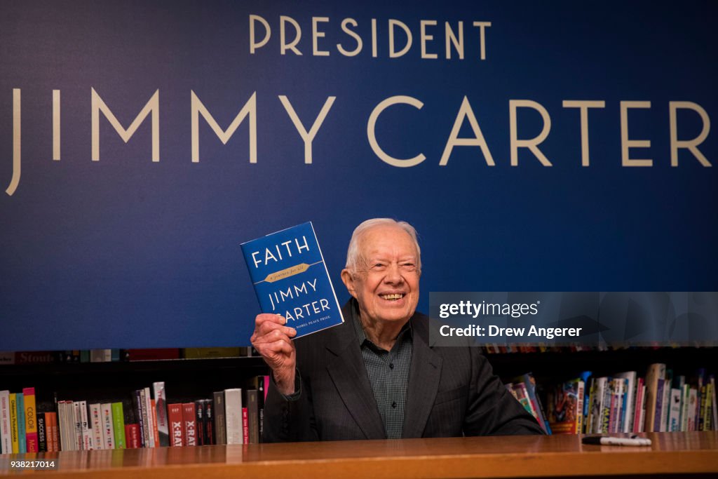 Jimmy Book Former U.S. President Jimmy Carter holds up a copy of his new book ...