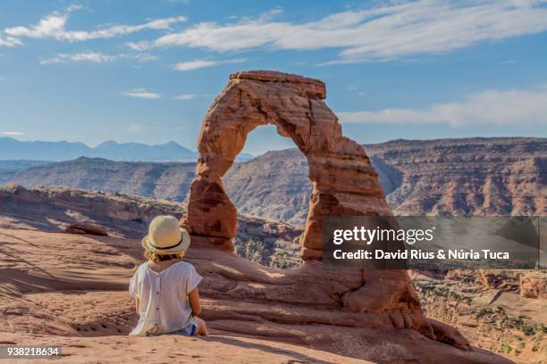 little girl observing the delicated arch - arches nationalpark stock-fotos und bilder