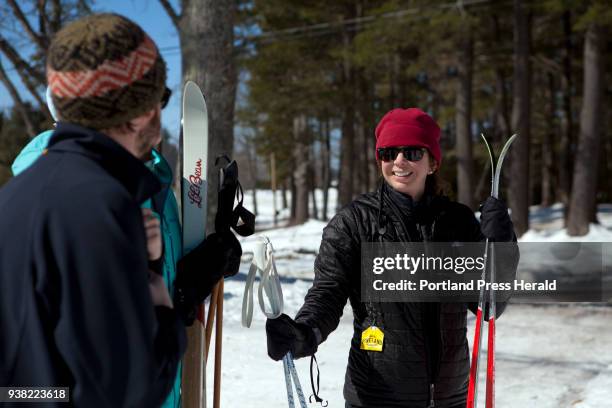 Becca Boulos of South Portland, right, chats with Ryan Rodel of Portland after cross country skiing at Pineland Farms in New Gloucester on Sunday,...