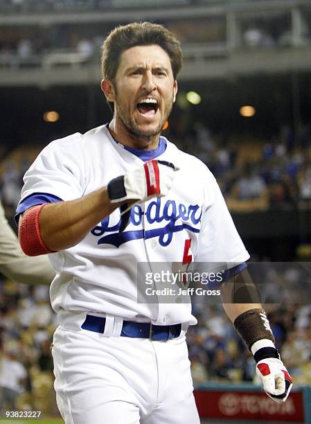 Nomar Garciaparra of the Los Angeles Dodgers celebrates after hitting a walk off two-run homerun in the tenth inning against the San Diego Padres at...