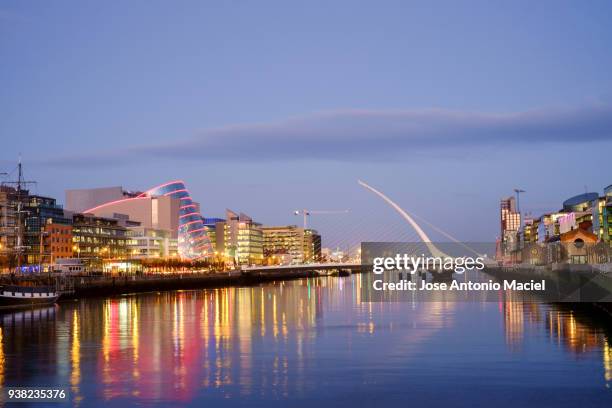 reflections on the liffey river in dublin - dublin city skyline stock-fotos und bilder